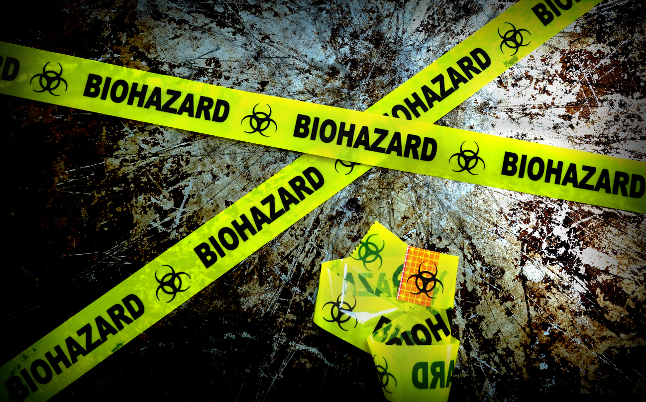 yellow biohazard tape on grunge background